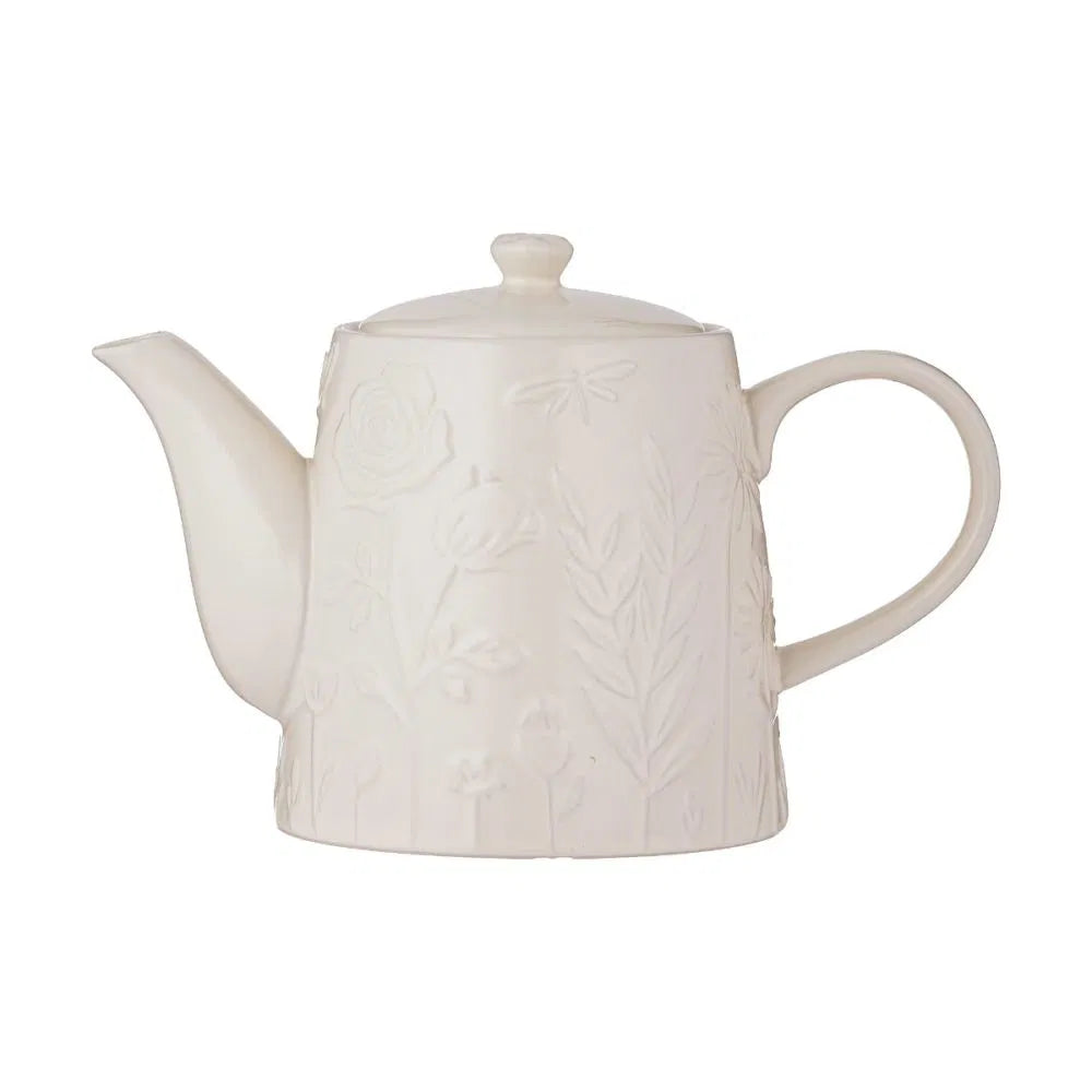 White ceramic teapot with floral patterns on a white background