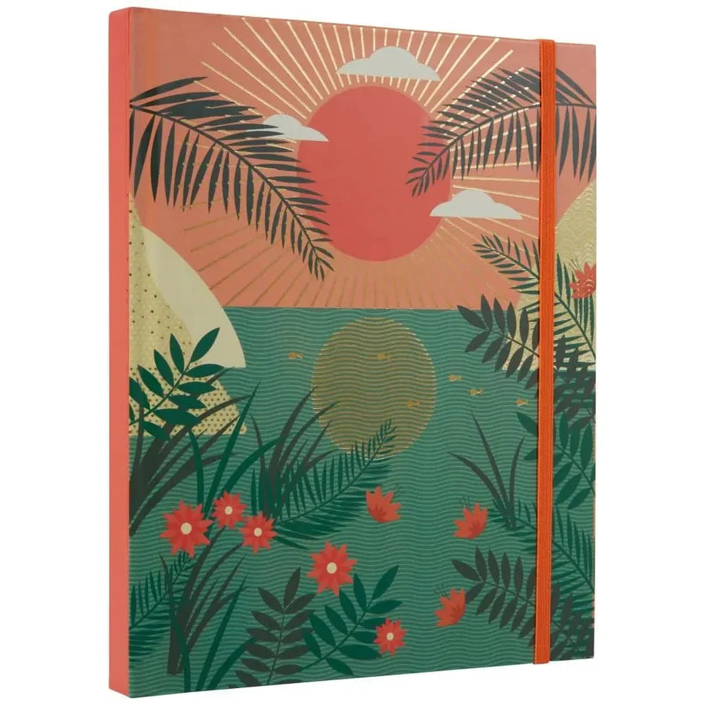 angled view of Notebook with a tropical design featuring palm leaves, flowers, and a sunset on the cover.