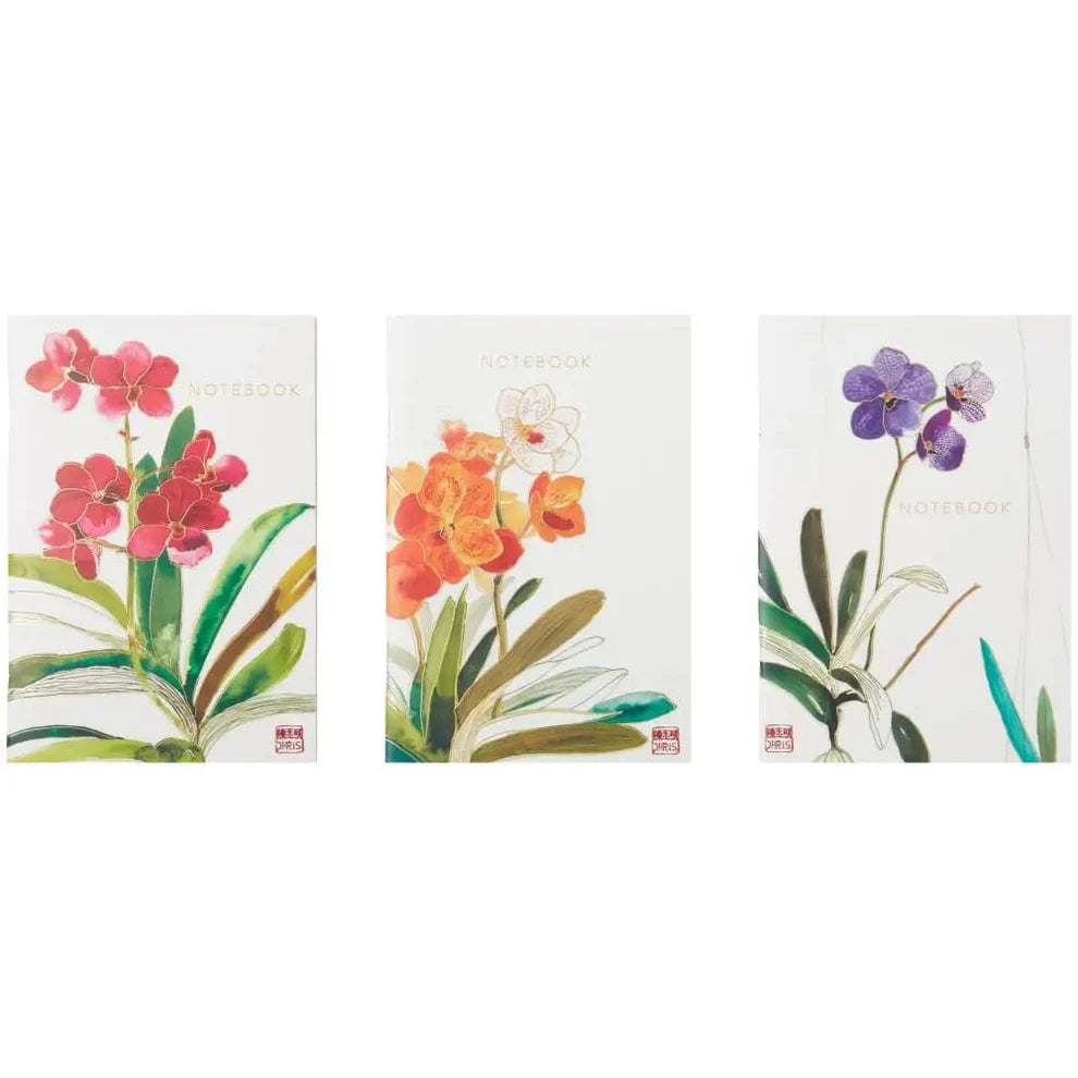 Three floral notebooks with different orchid designs on a white background