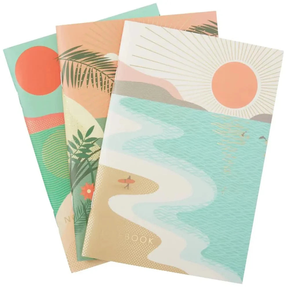 Set of three notebooks with beach-themed covers on a white background