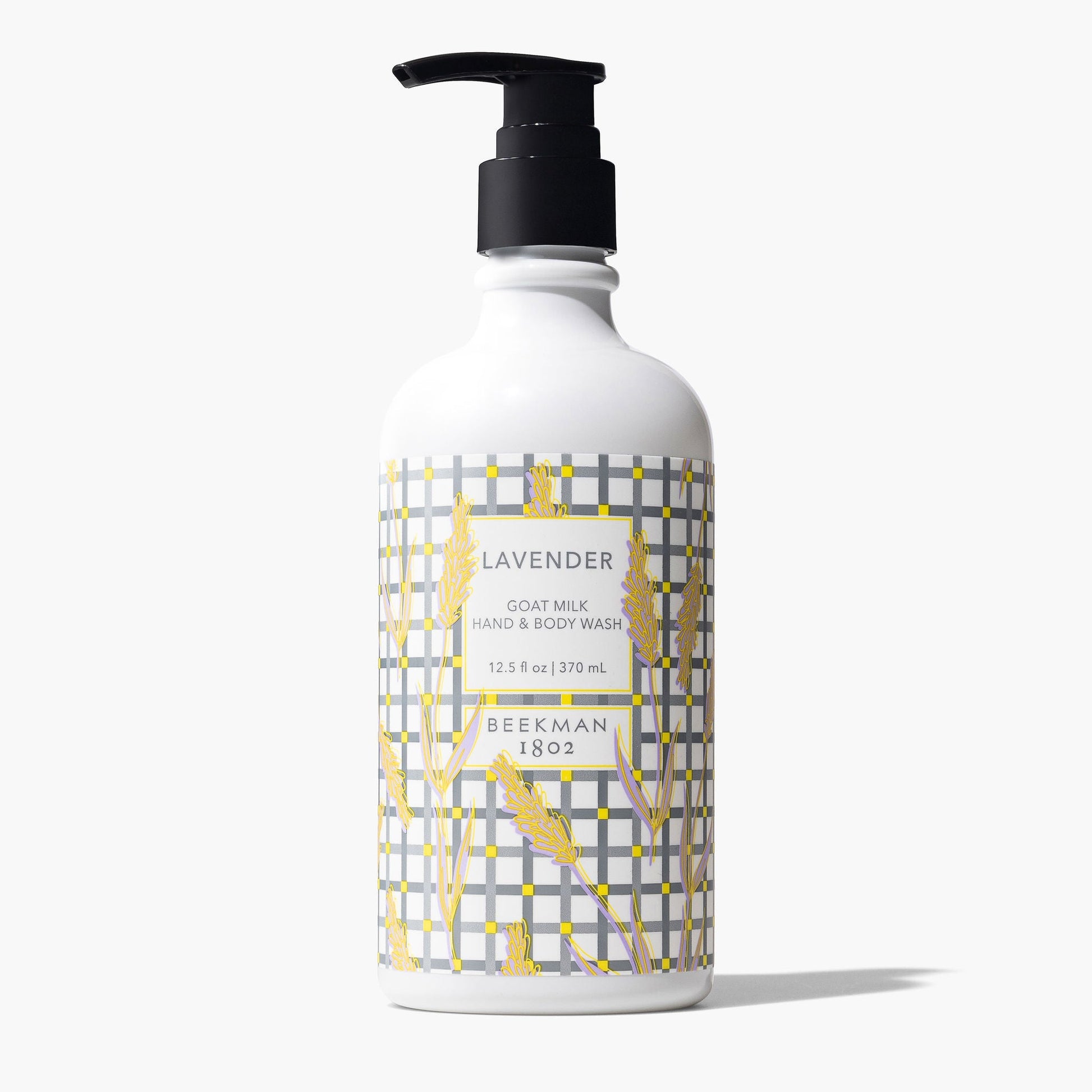pump bottle of Lavender Goat Milk hand and body wash with a grey plaid and wheat stalk design printed label.