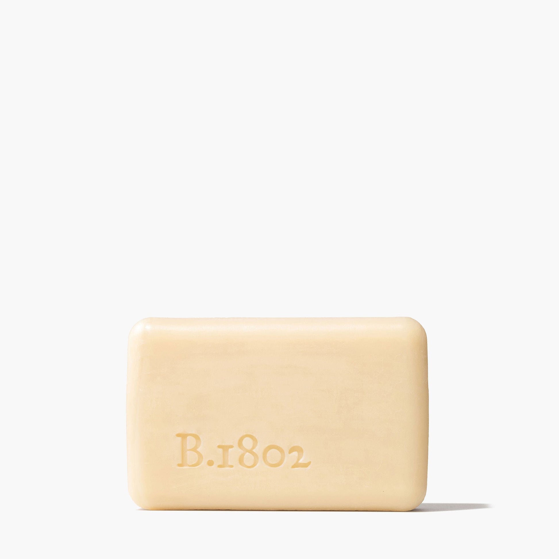 unwrapped bar of lilac dream soap stamped with "B.1802" logo.