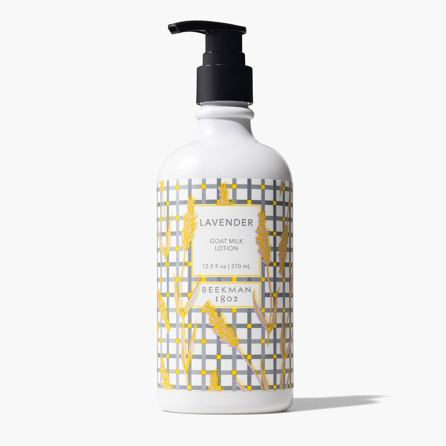 pump bottle of Lavender Goat Milk lotion with a grey plaid and wheat stalk design printed label.