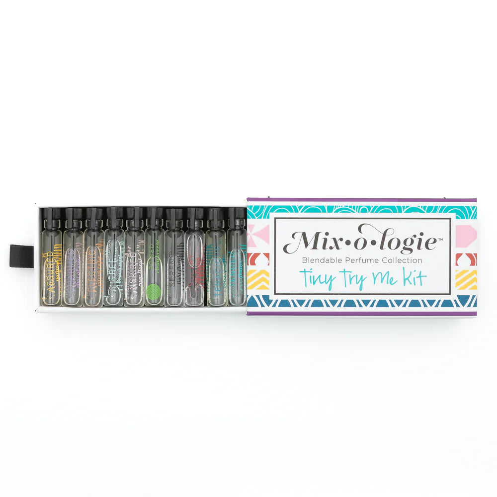 A boxed perfume kit labeled 'Mixologie Blendable Perfume Collection Tiny Try Me Kit' with multiple clear glass vials containing fragrances 