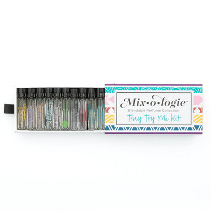 A boxed perfume kit labeled 'Mixologie Blendable Perfume Collection Tiny Try Me Kit' with multiple clear glass vials containing fragrances 