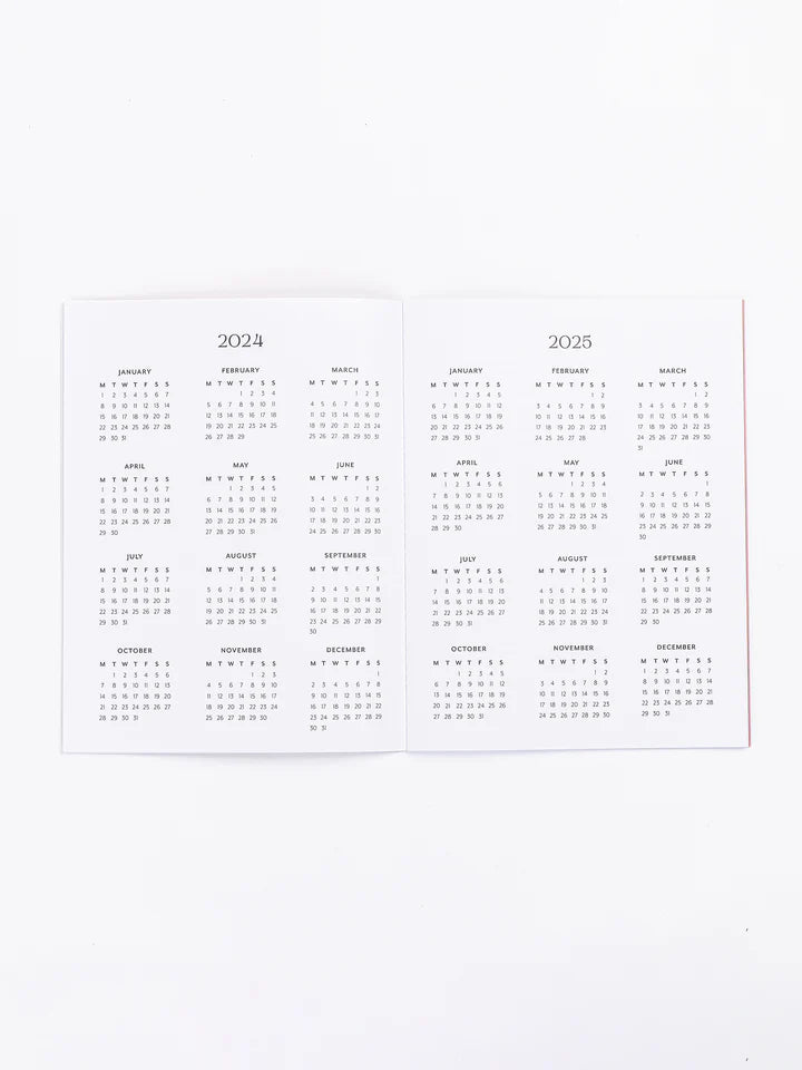 inside pages of planner with 2024 and 2025 calendars.
