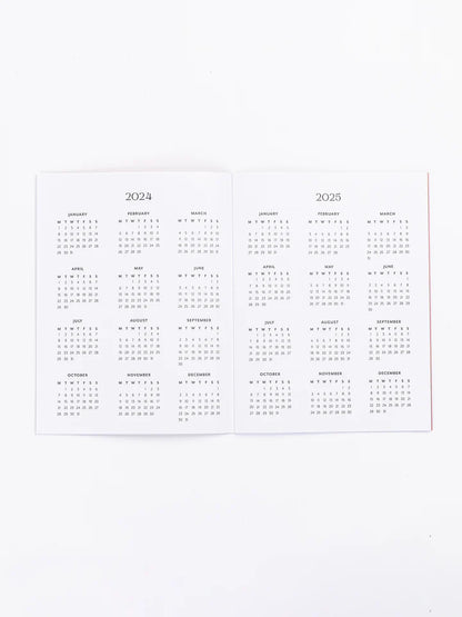 inside pages of planner with 2024 and 2025 calendars.