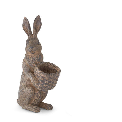 Decorative rabbit statue holding a basket on a white background