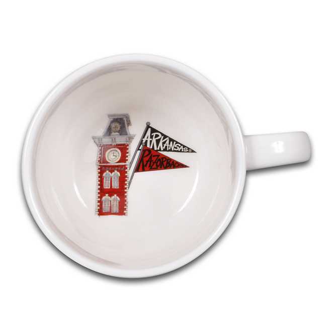 top view of white mug showing university building and two pennant flags printed in the bottom of the mug.