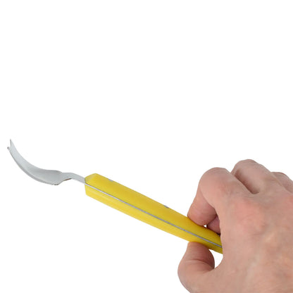 Hand holding a corn butter knife with a curved blade on a white background