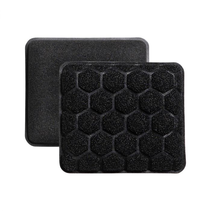Two rectangular black scrubbing sponges with a honeycomb pattern.