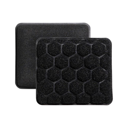 Two rectangular black scrubbing sponges with a honeycomb pattern.