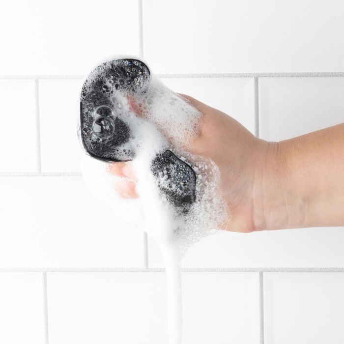 hand squeezing Power Scrubber Sponges filled with suds