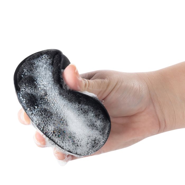 hand squeezing Power Scrubber Sponges full of suds