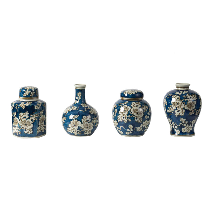 4 blue and white vases in a row against a white background