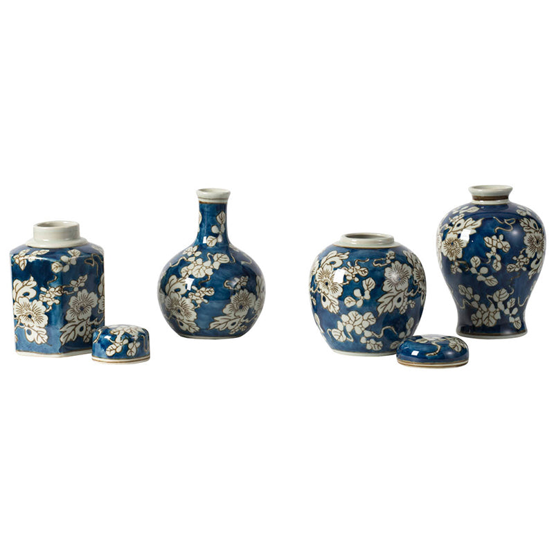 4 blue and white vases in a row against a white background,  the jar vases have their lids off