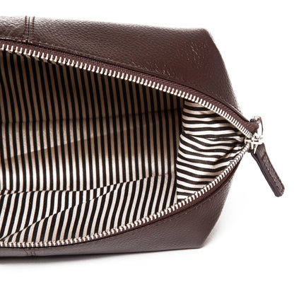 top down view of the stanford toiletry bag in brown showing the stripe interior