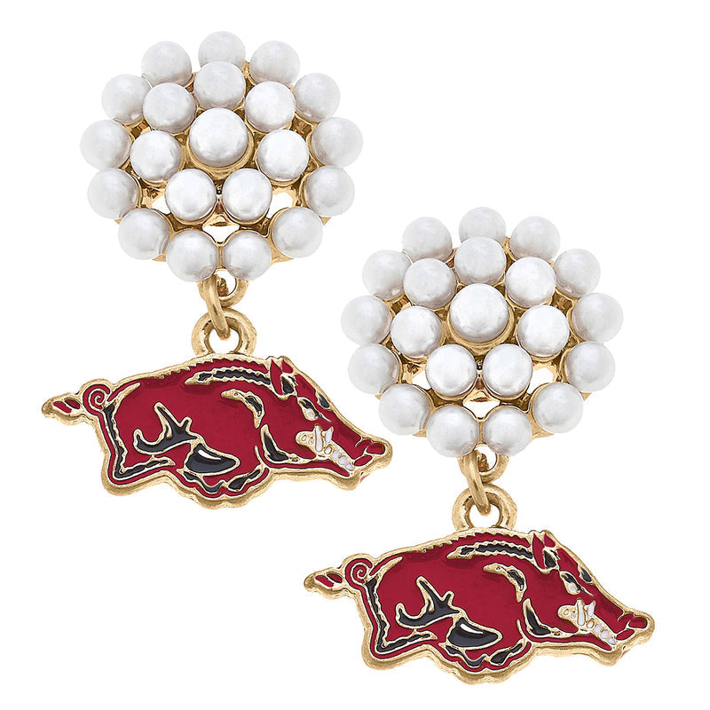 earrings with a cluster of small pearls and an enameled razorback pendant hanging from it.