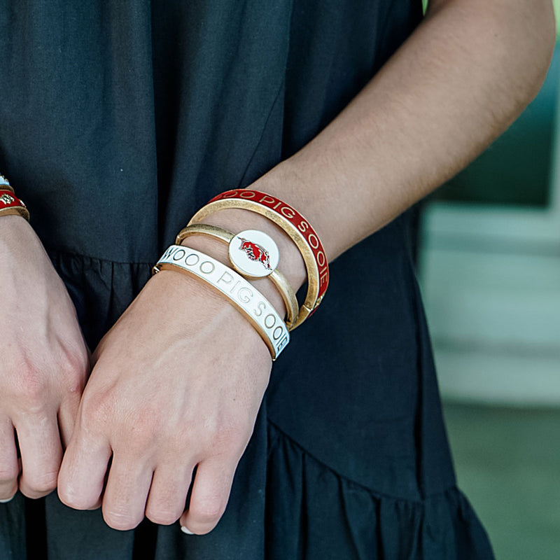 view of a person's arm with all 3 razorback bangles on their wrist.