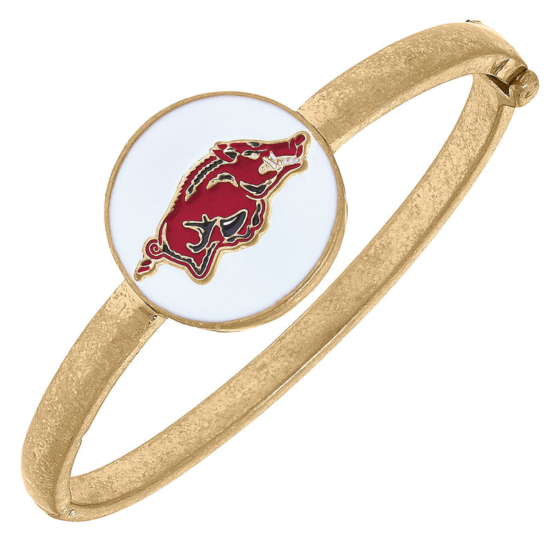 gold bangle with white enamel disc with a red razorback on it.