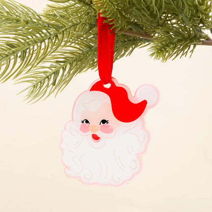 Santa Claus ornament hanging on a Christmas tree branch