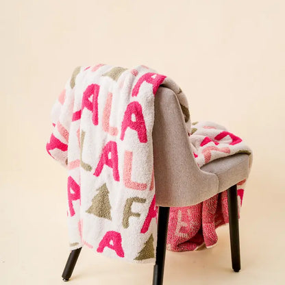 Fa la la blanket draped over the back of a chair.