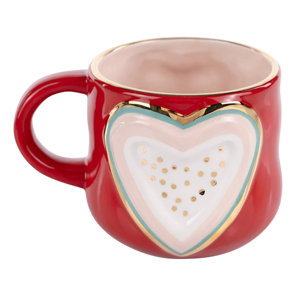 Red mug with a heart-shaped design on a white background
