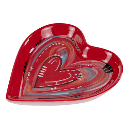 side view of Heart-shaped ceramic plate with colorful design on a white background