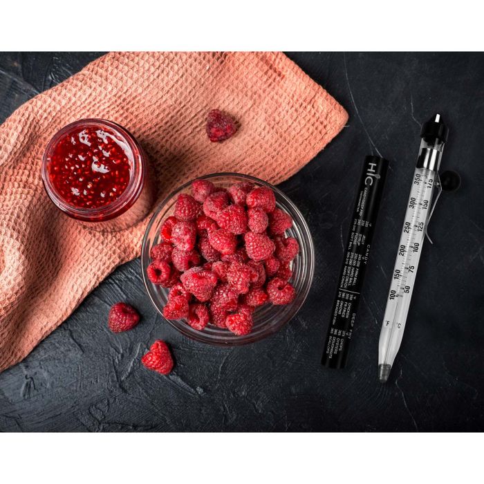 Candy or Deep Fry Thermometer set on a table with a bowl of berries and jam