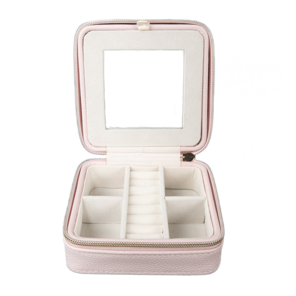 pink travel jewelry box open showing bottom section and built-in mirror.