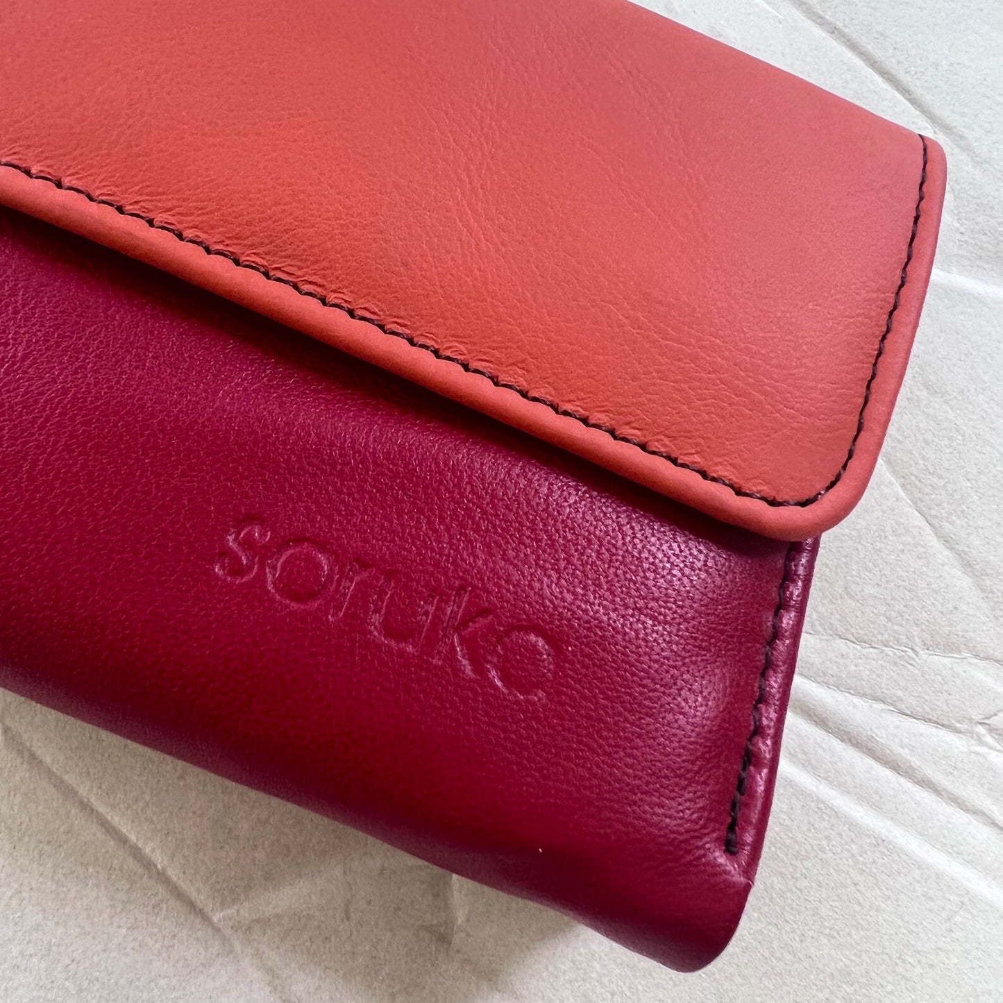 close-up of cranberry rings wallet