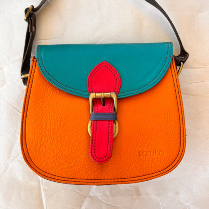 Tangerine Ally bag with a teal flap.