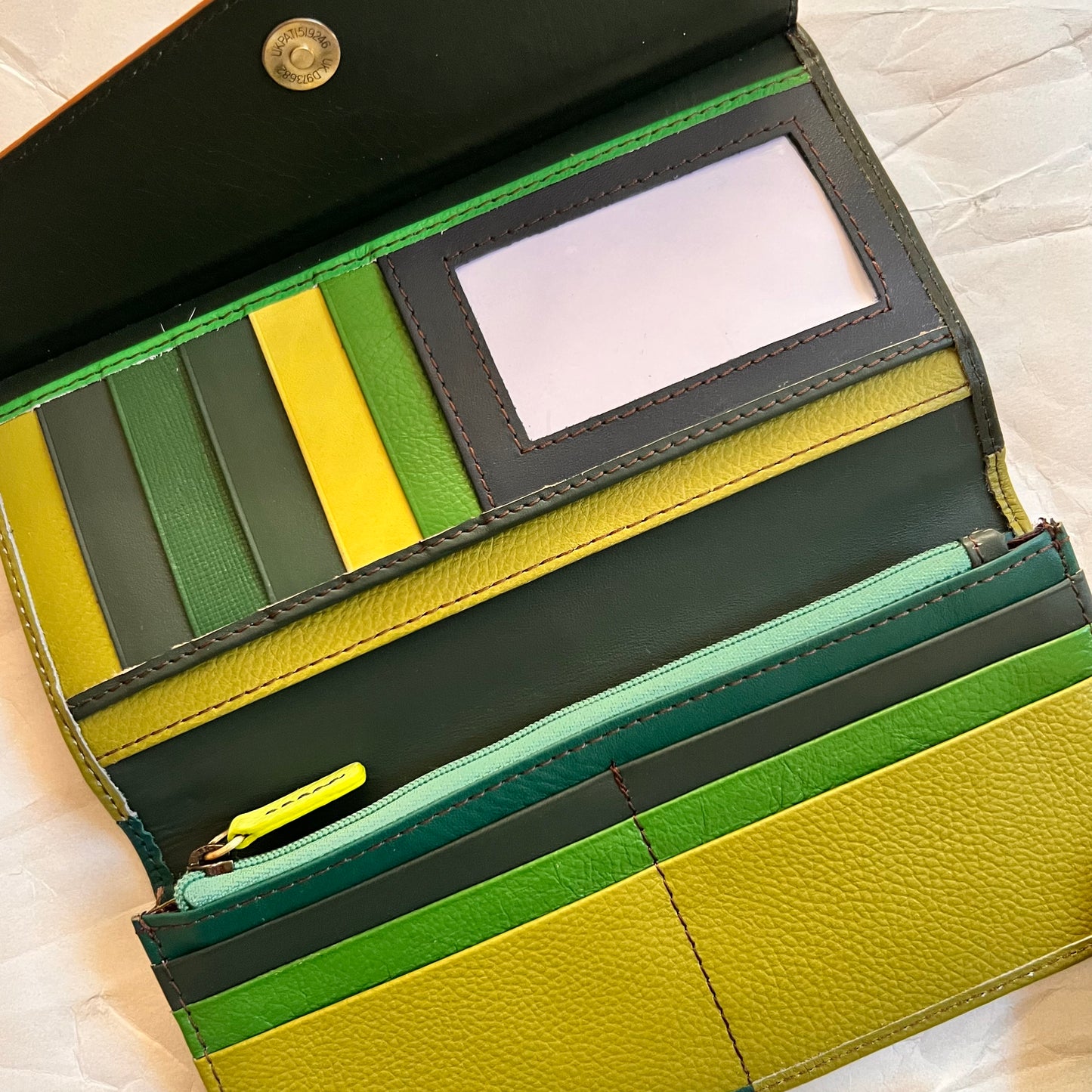 judith wallet open showing multi-colored card slots and pockets.