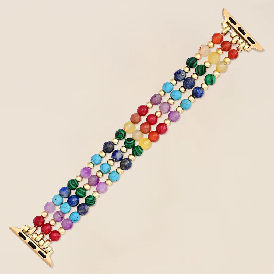 rainbow gemstone beaded watchband laying flat on a light background
