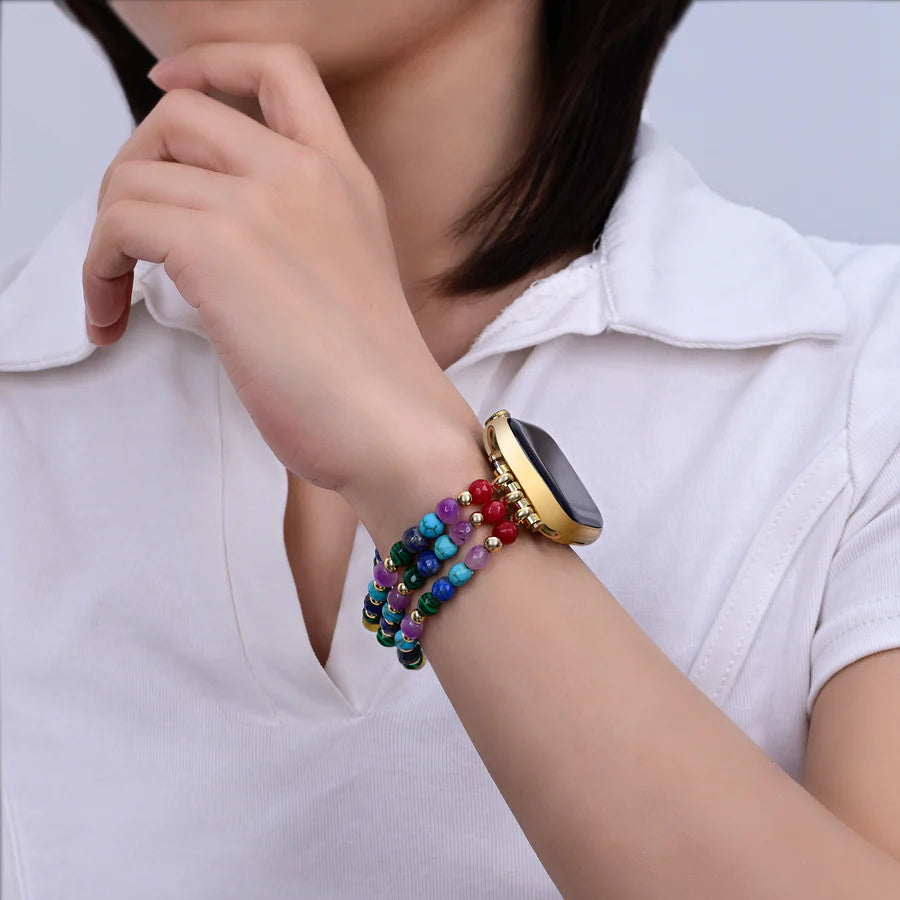 Smartwatch with a rainbow gemstone beaded band on person's wrist
