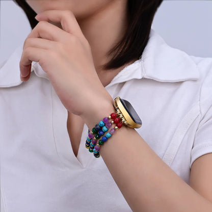 Smartwatch with a rainbow gemstone beaded band on person's wrist