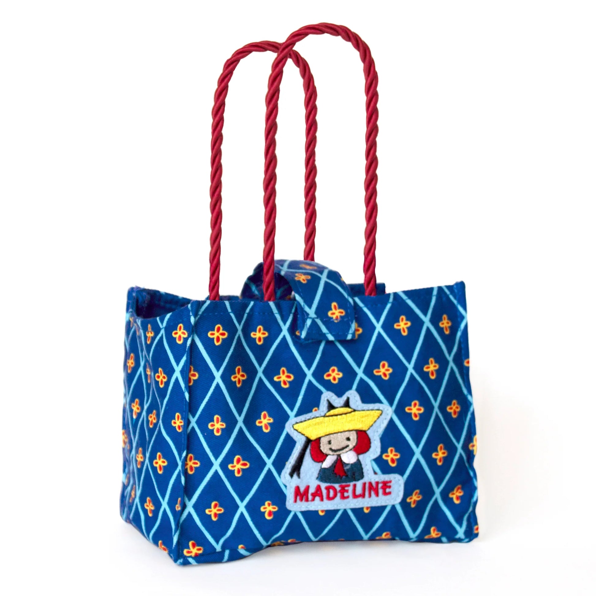 an empty Madeline Tote Bag that holds Genevieve the Dog on a white background