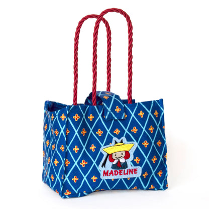 an empty Madeline Tote Bag that holds Genevieve the Dog on a white background