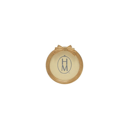 round gold frame with bow design on top