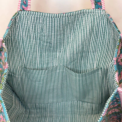 interior view of floral tote bag shown striped lining