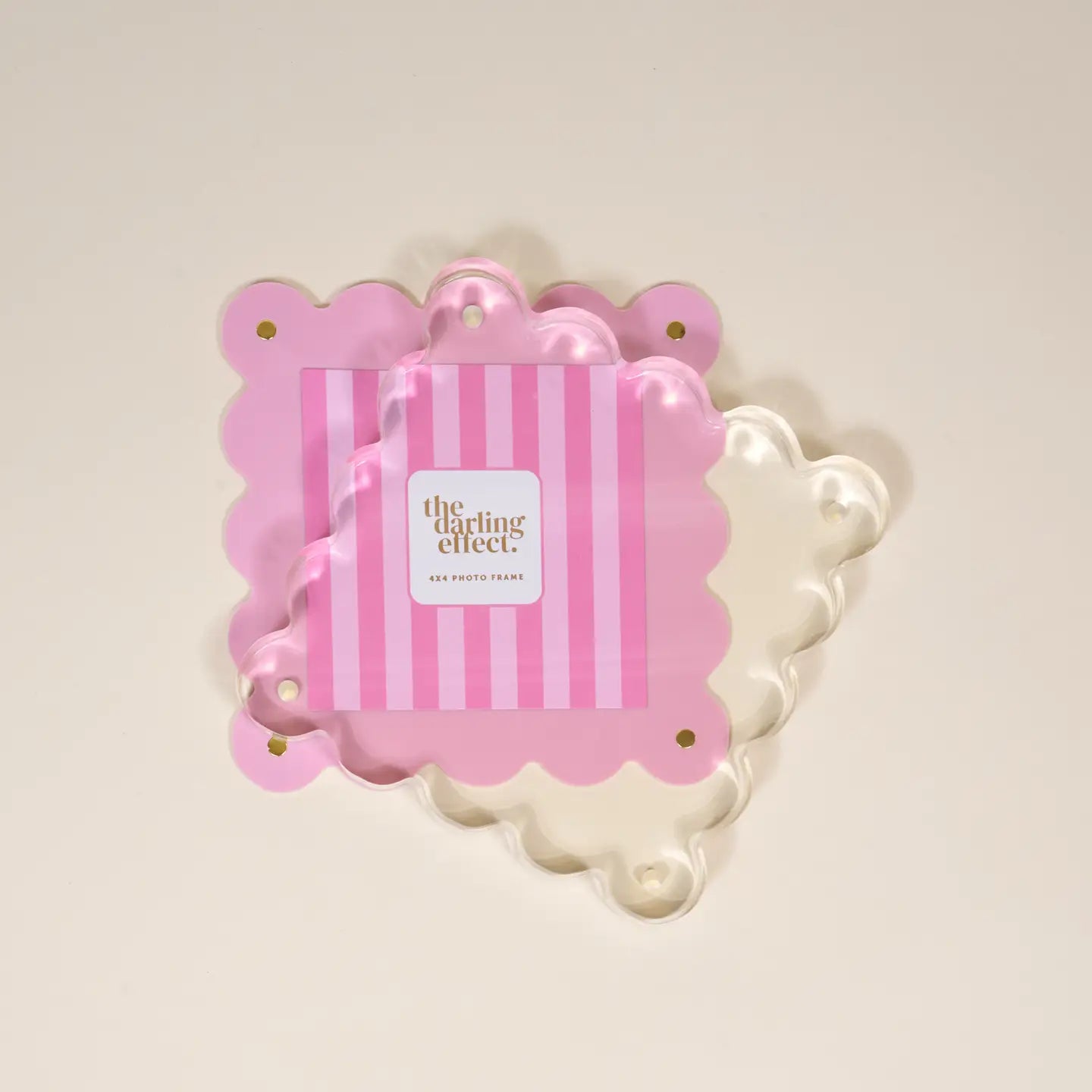 pink acrylic frame partially separated by the magnet to allow for replacing a photo