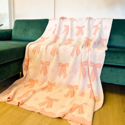 bow blanket draped on a couch