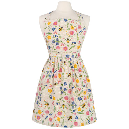 tan apron covered in yellow, blue, and pink flowers, with bees on a mannequin