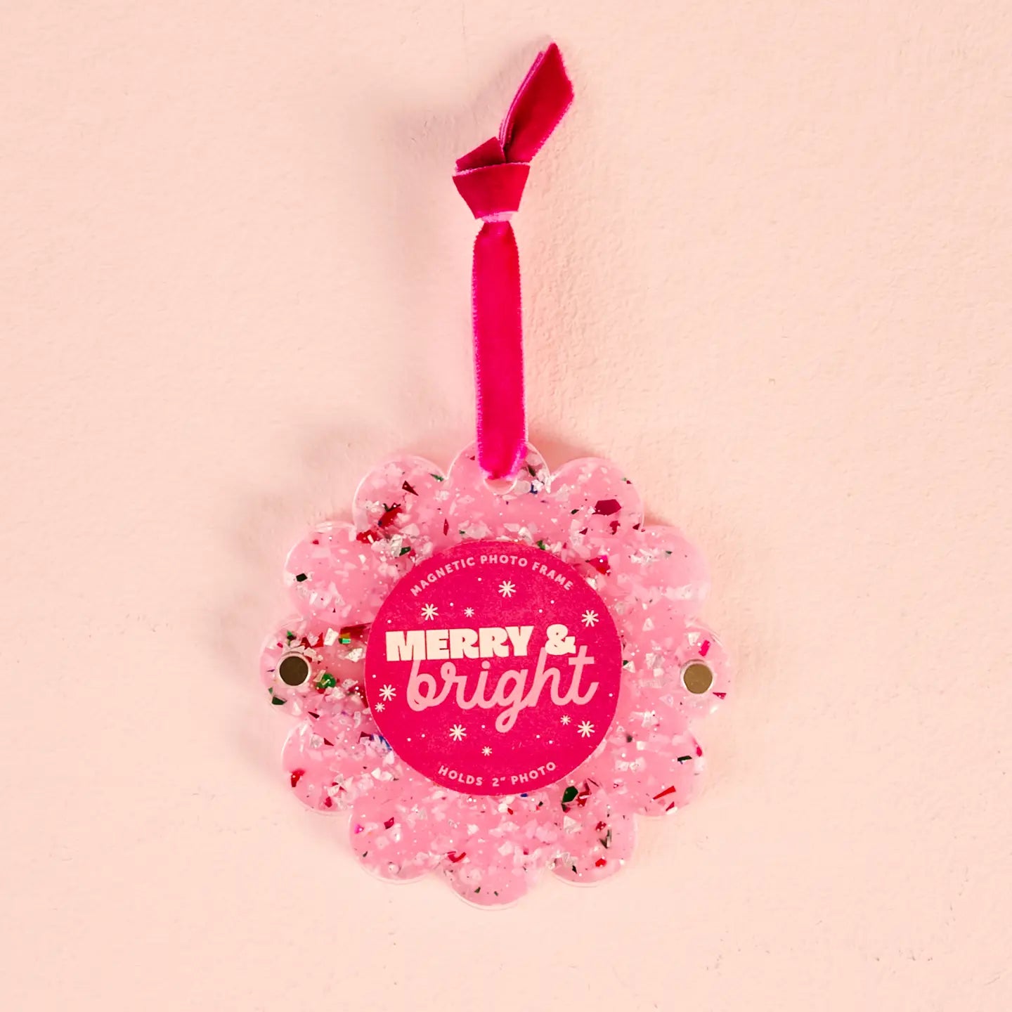 Pink Confetti round ornament frame shown on a beige background