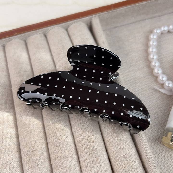 Black with White Polka Dots Claw Clip on a jewelry holder
