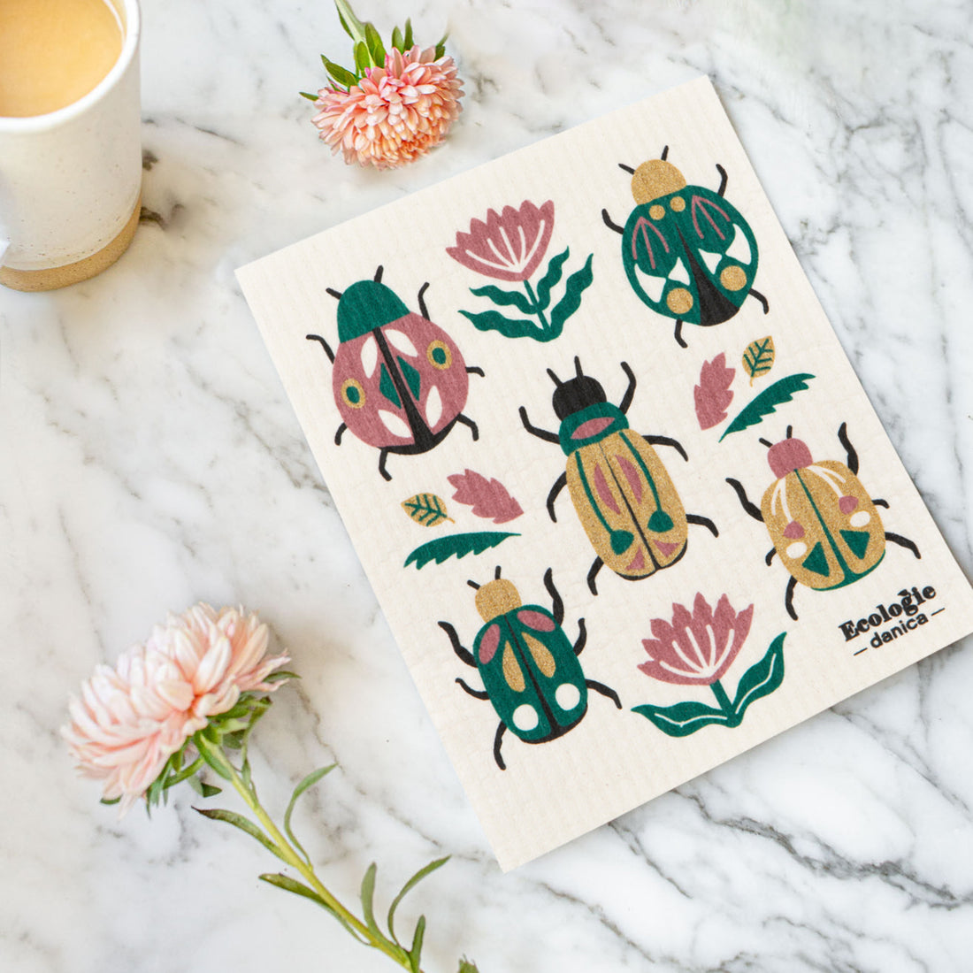 dishcloth with beetle design printed on it  on an counter