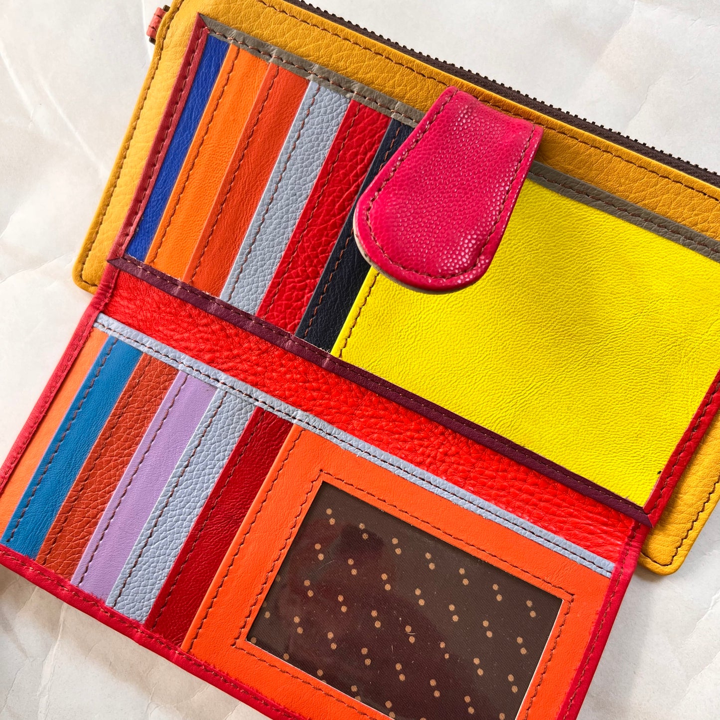 interior view of kimber wallet showing colorful card slots, pockets, and clear spot for ID.