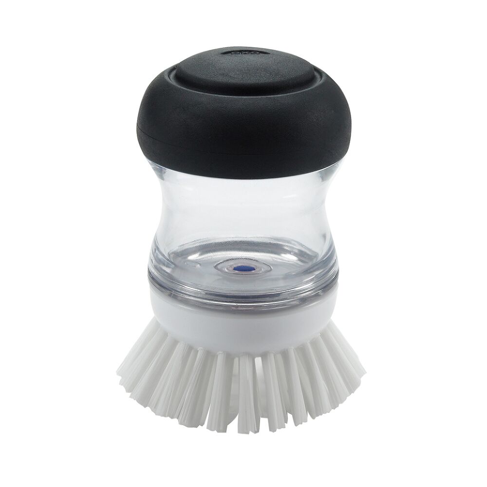 scrub brush with white bristles and black knob handle.