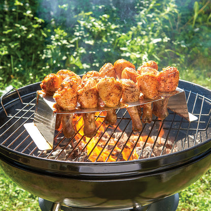 Grilling And Roasting Rack filled with chicken legs and set on a hot grill