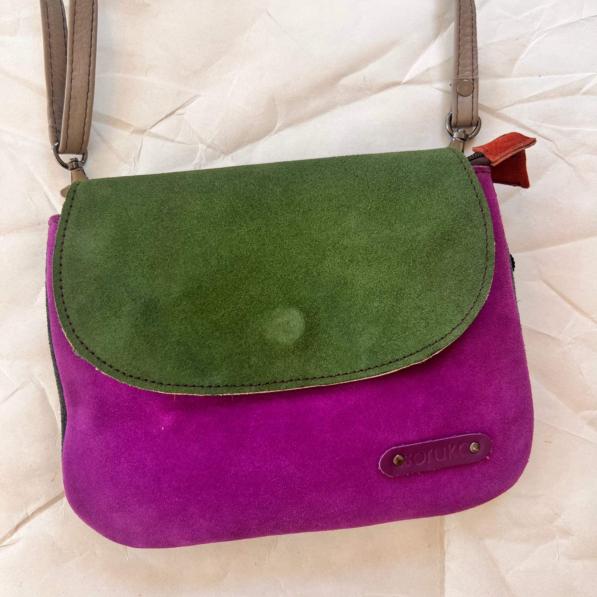 leo purse with purple body and green flap.